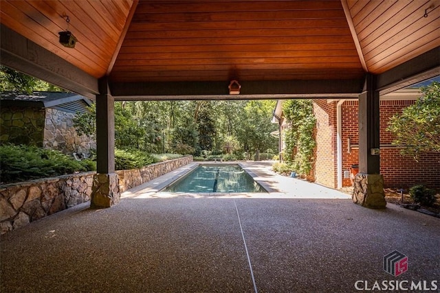 view of swimming pool featuring a patio area and a gazebo