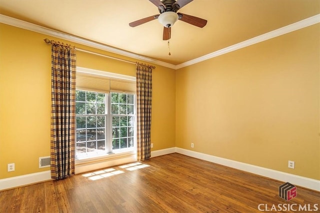 empty room with ceiling fan, ornamental molding, and hardwood / wood-style floors