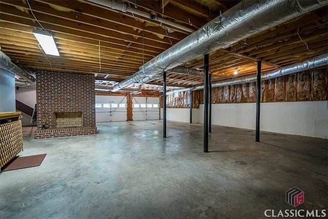 basement featuring a brick fireplace