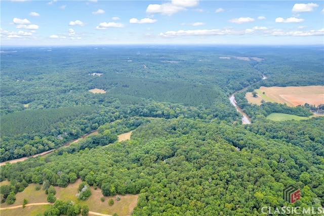 birds eye view of property with a wooded view