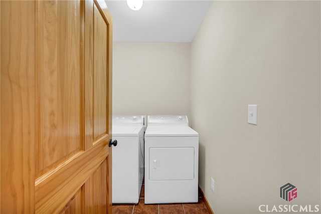 washroom featuring separate washer and dryer, tile patterned flooring, and laundry area