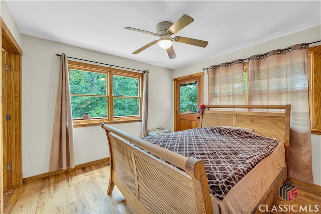 bedroom featuring baseboards, light wood-type flooring, and ceiling fan