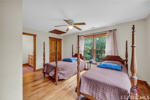 bedroom with visible vents, a ceiling fan, light wood finished floors, and baseboards