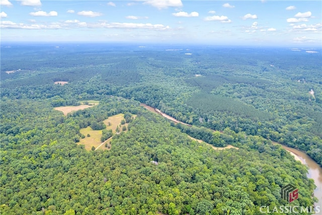 birds eye view of property with a forest view