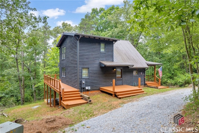 view of front of home with a deck and metal roof