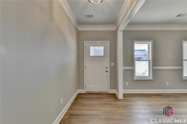 entrance foyer with crown molding and light hardwood / wood-style floors