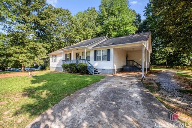 ranch-style home with a carport, covered porch, and a front yard