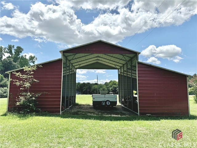 view of outbuilding featuring a carport and a yard