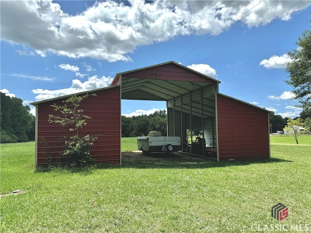 view of outbuilding with a carport and a yard