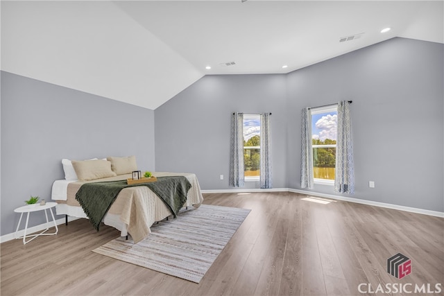 bedroom featuring lofted ceiling and light wood-type flooring