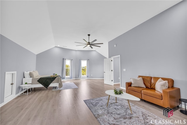 living room with light hardwood / wood-style flooring, ceiling fan, and lofted ceiling