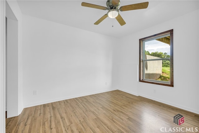 empty room featuring ceiling fan and light hardwood / wood-style flooring