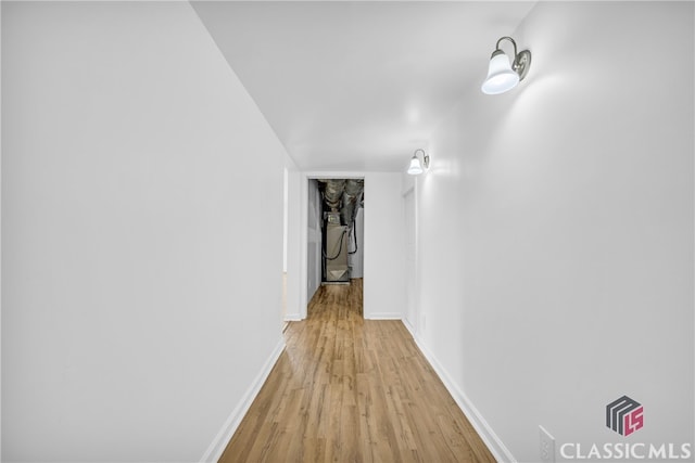 corridor with light wood-type flooring