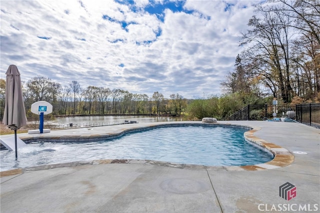 view of pool featuring a water view and a patio