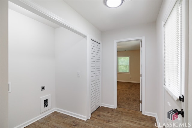 laundry room with laundry area, wood finished floors, electric dryer hookup, and baseboards