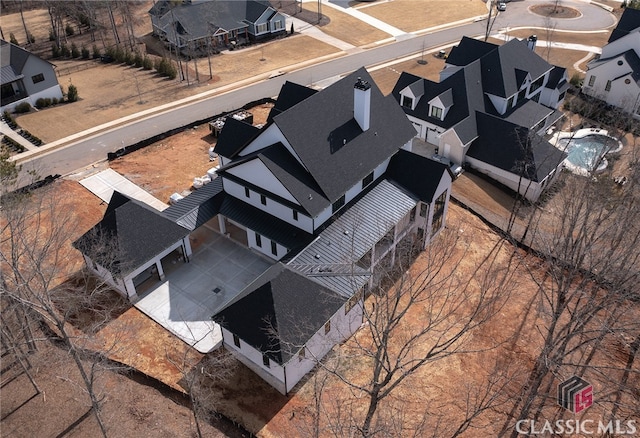 birds eye view of property with a residential view