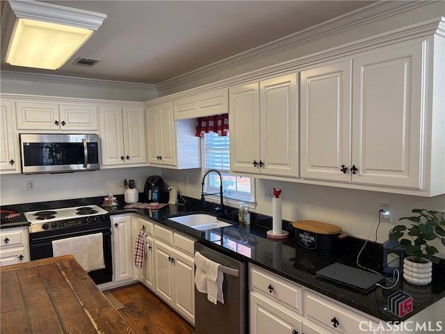 kitchen featuring white cabinets, crown molding, sink, and stainless steel appliances