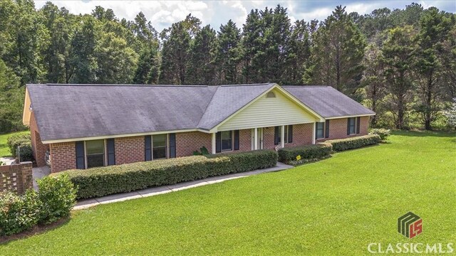 ranch-style home featuring a front lawn