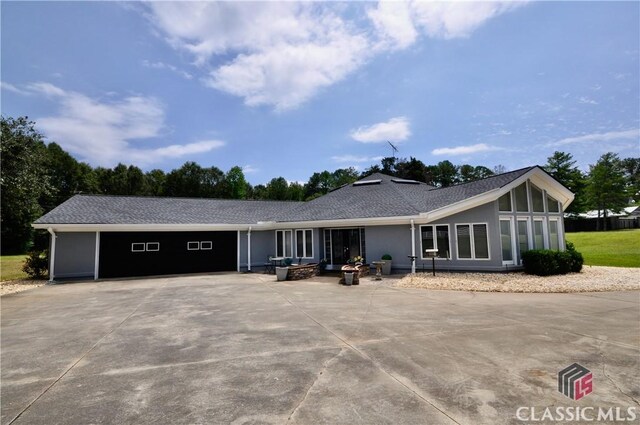 single story home featuring a garage and a sunroom