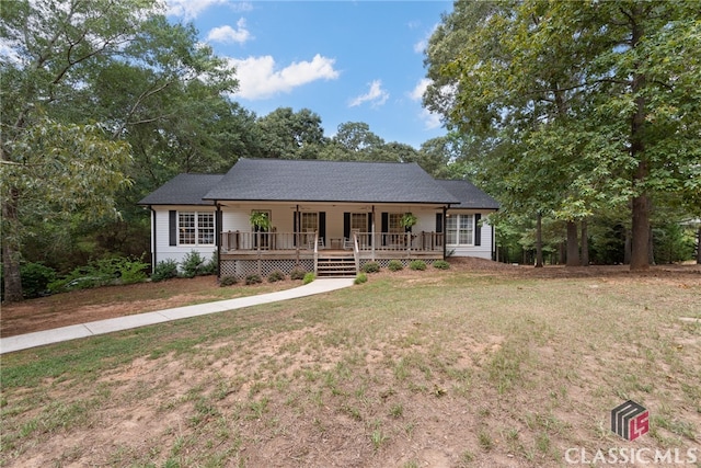 ranch-style home with covered porch and a front yard