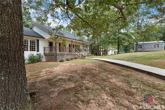 view of yard featuring covered porch