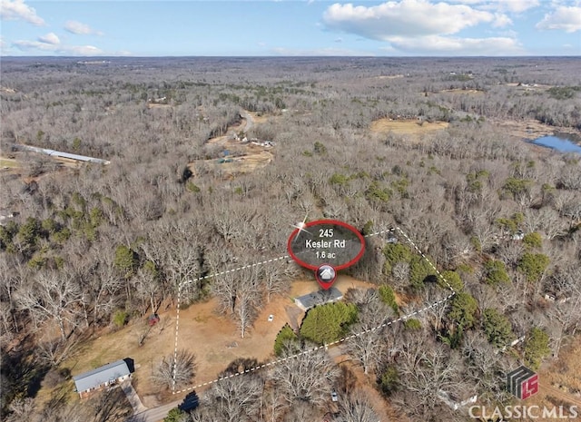 birds eye view of property with a wooded view