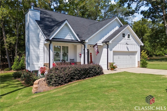 view of front facade featuring a garage, a front yard, and covered porch