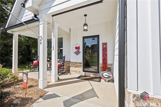 view of exterior entry with covered porch