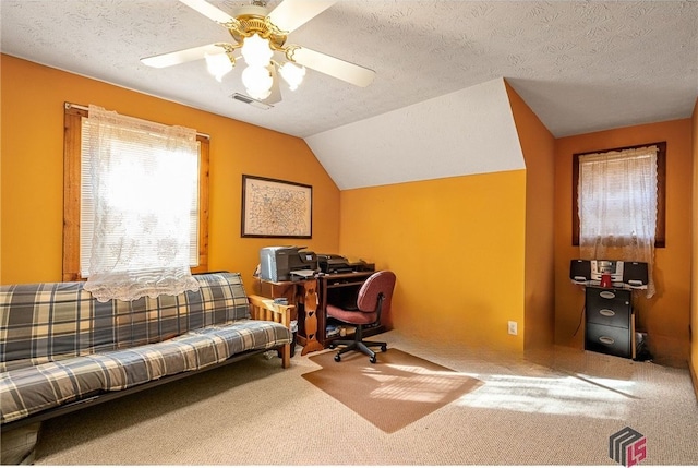 office with ceiling fan, vaulted ceiling, and a textured ceiling