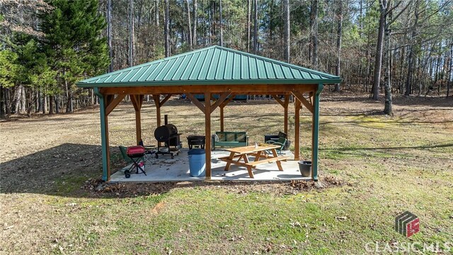 view of community with a yard, a patio, and a gazebo