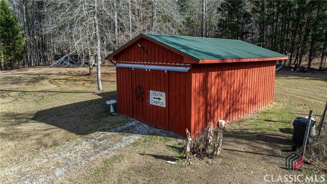 view of outbuilding with a yard