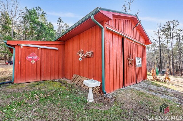 view of outbuilding with a lawn