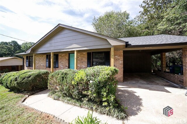 ranch-style house featuring a carport