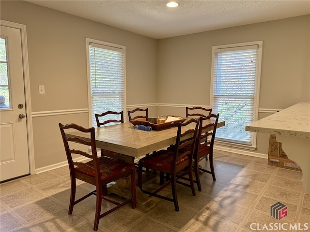 dining space with a textured ceiling