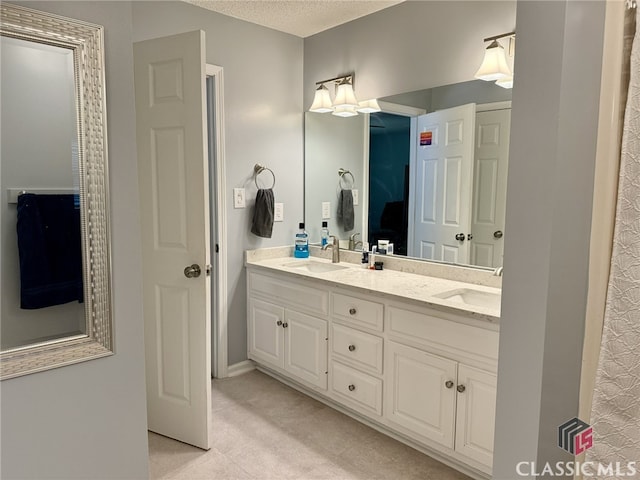 bathroom with vanity and a textured ceiling