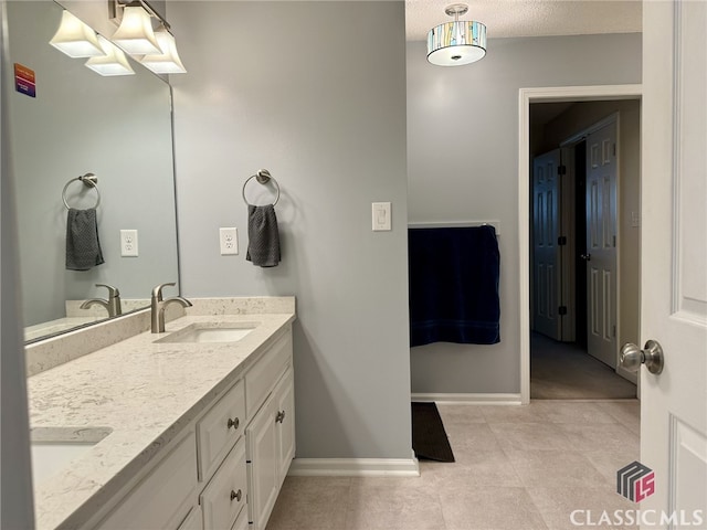 bathroom featuring vanity, a textured ceiling, and tile patterned flooring