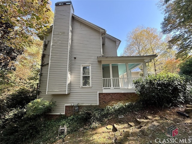 view of property exterior with covered porch