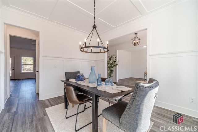 dining space featuring dark wood-type flooring, crown molding, a notable chandelier, and coffered ceiling