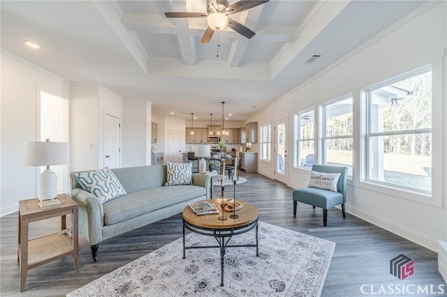 living room featuring beam ceiling, dark hardwood / wood-style floors, ceiling fan, crown molding, and coffered ceiling