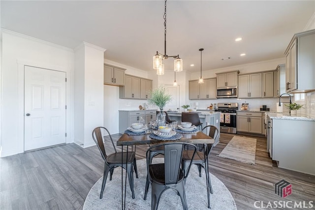 dining room with dark hardwood / wood-style flooring and crown molding