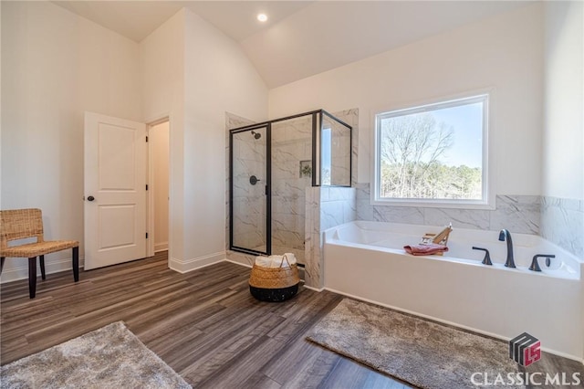 bathroom with lofted ceiling, hardwood / wood-style flooring, and shower with separate bathtub