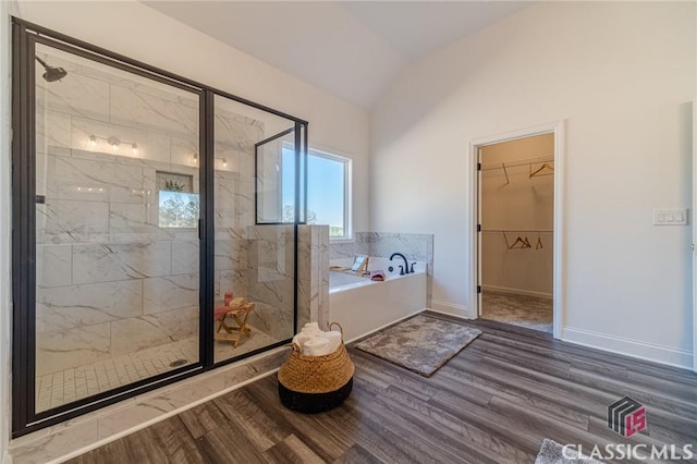 bathroom featuring hardwood / wood-style floors, independent shower and bath, and vaulted ceiling