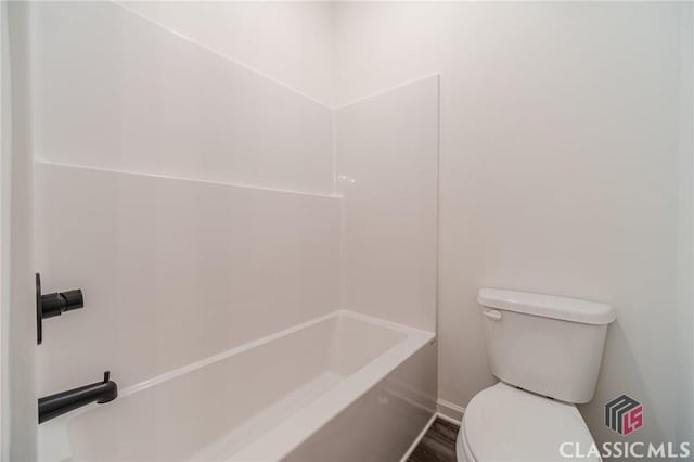 bathroom with toilet, plus walk in shower, and hardwood / wood-style floors