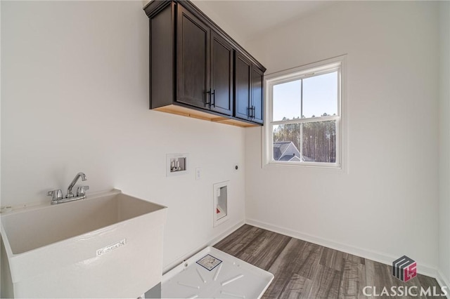 laundry area featuring electric dryer hookup, dark wood-type flooring, hookup for a washing machine, cabinets, and sink