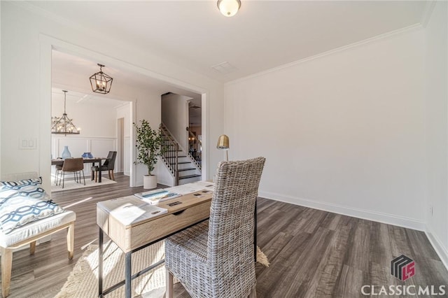 dining room with dark hardwood / wood-style floors, crown molding, and a chandelier