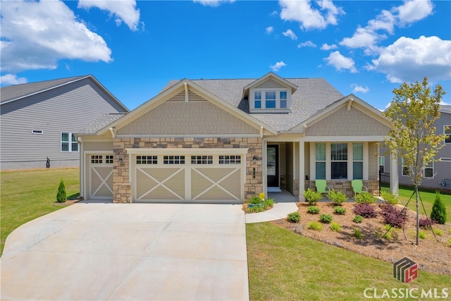 craftsman-style house featuring a porch, a garage, and a front lawn