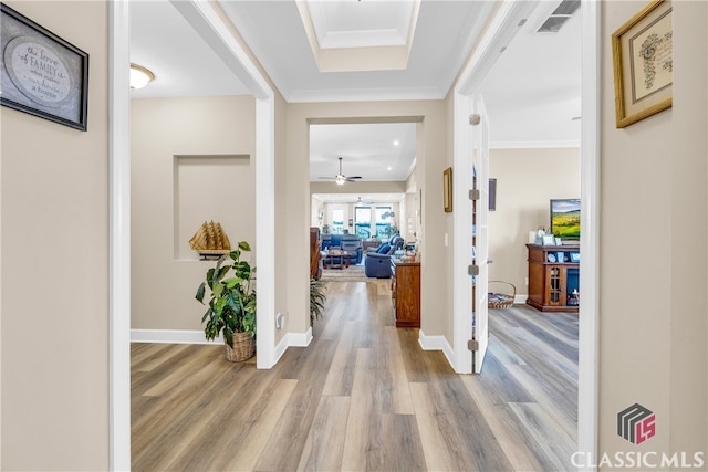 hallway featuring hardwood / wood-style flooring and ornamental molding