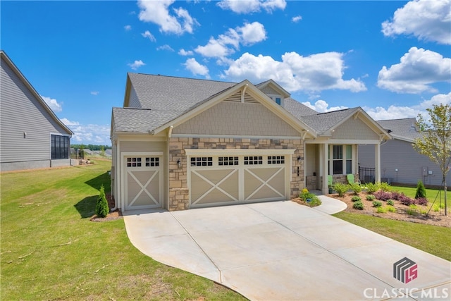 craftsman house with a front yard and a garage