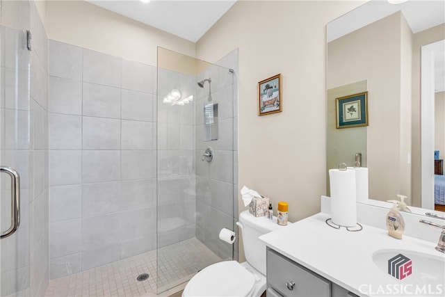 bathroom with an enclosed shower, toilet, and vanity