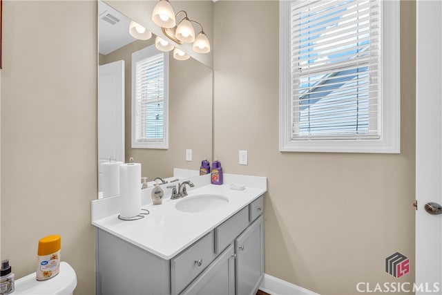 bathroom with toilet and vanity